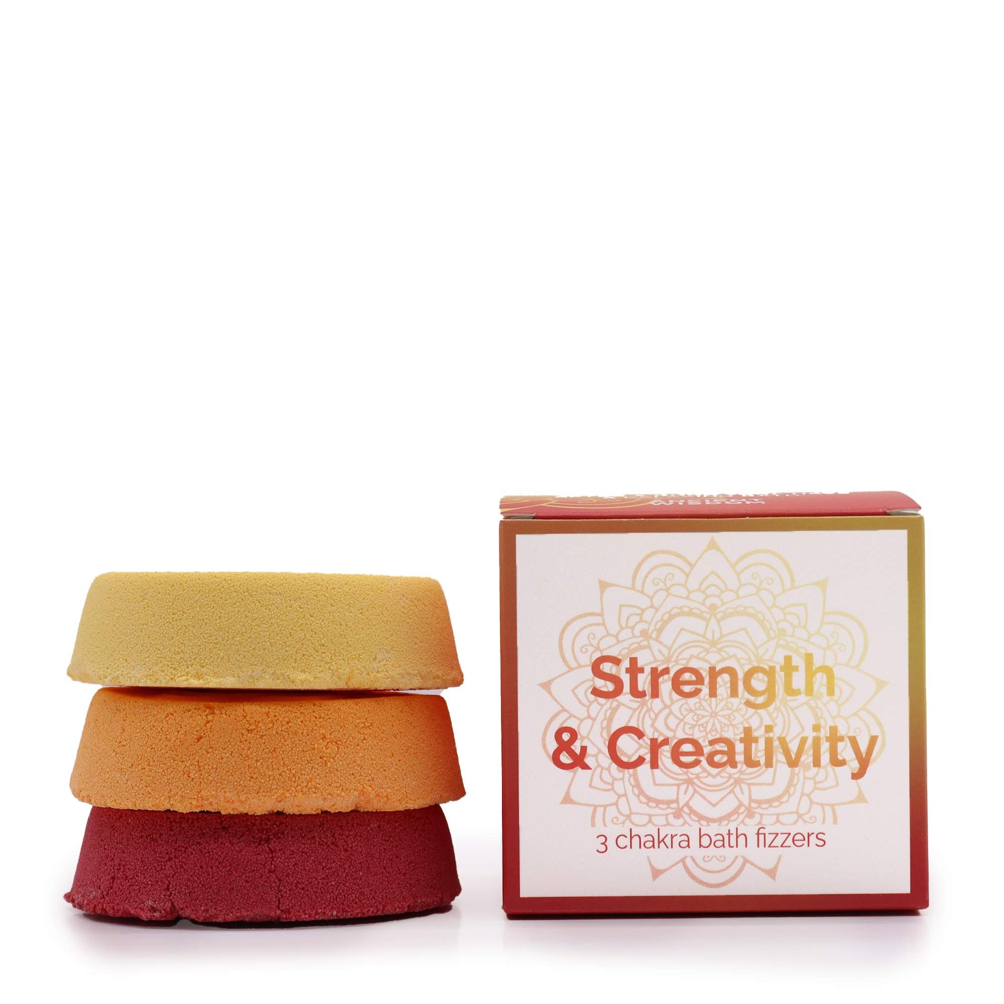 Tres bombas de baño Chakra en tonos amarillo, naranja y rojo junto a su caja